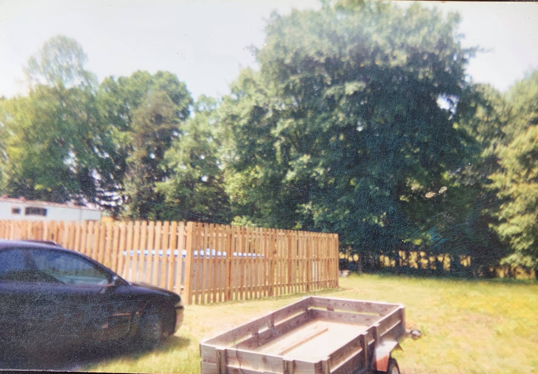 Tennessee Fence crew at work on a fence job site with a skid-steer